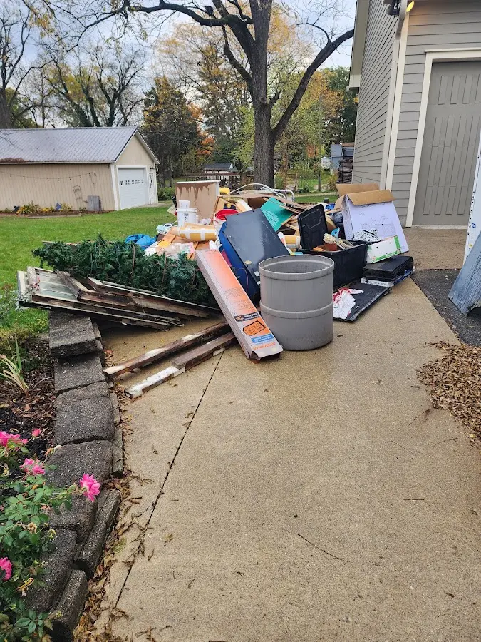 Dumpster being loaded with debris for Estate Cleanout Dumpster Rental in Southside